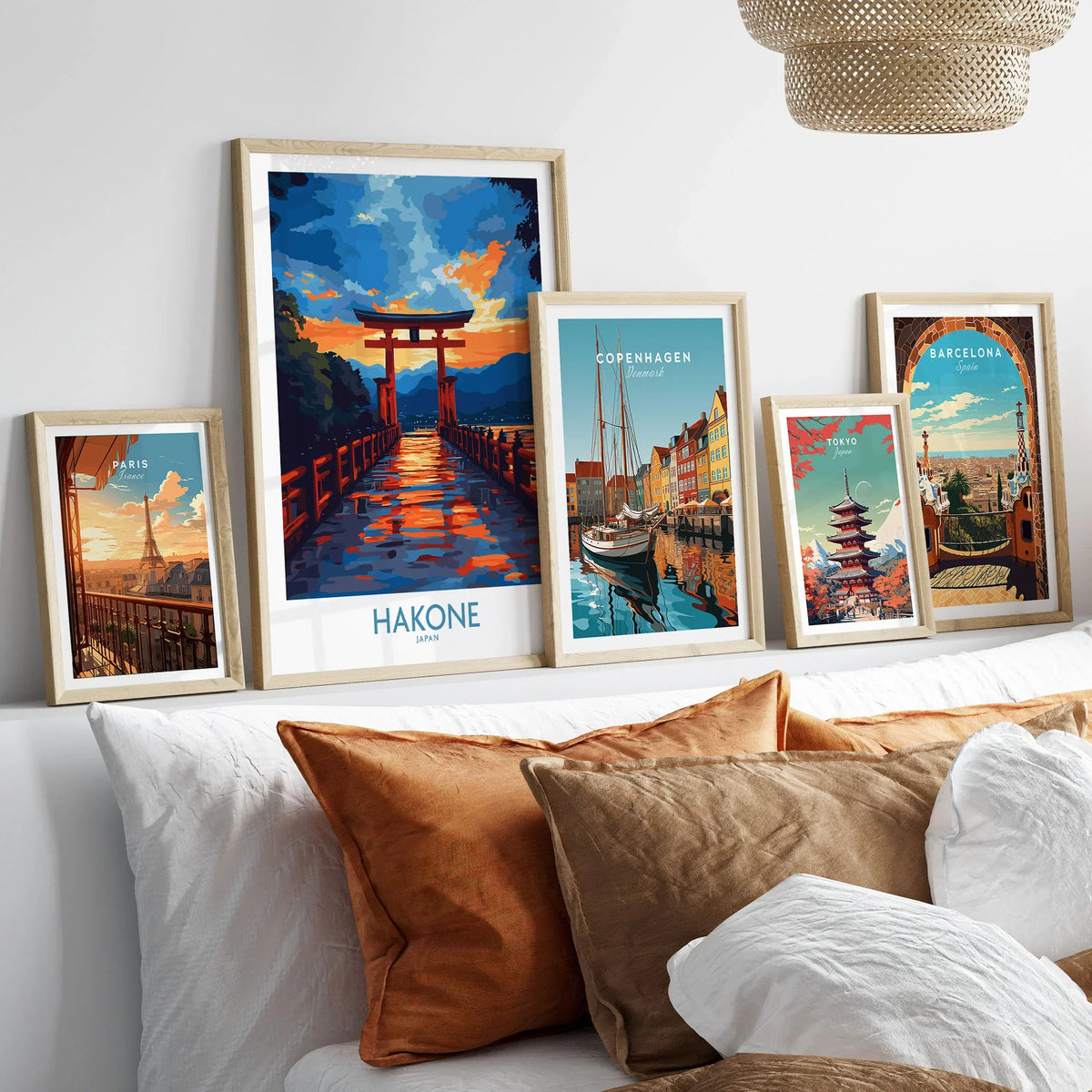 Hakone Wall Art - Japan Travel Poster in a gallery wall set of five framed travel prints in natural wood frames above a bed
