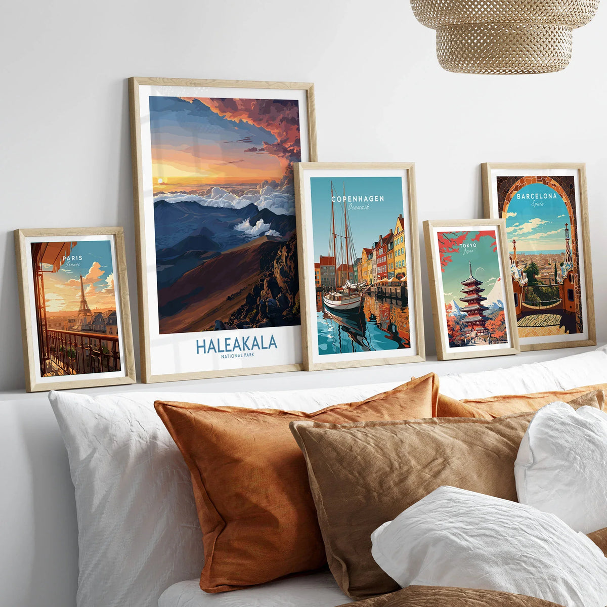 Haleakalā Craters Poster, Hawaiian Sunrise Print, Mountain Wall Decor in a gallery wall set of five framed travel prints in natural wood frames above a bed