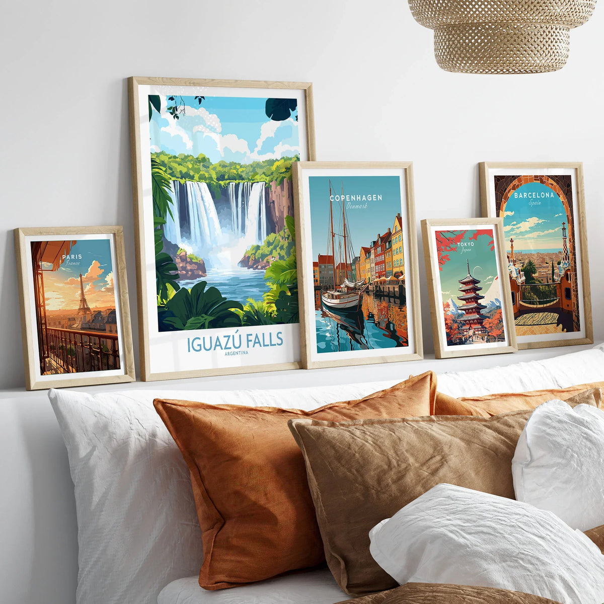 Iguazu Falls Travel Poster in a gallery wall set of five framed travel prints in natural wood frames above a bed