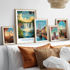 Iguazu Falls Wall Art Print in a gallery wall set of five framed travel prints in natural wood frames above a bed