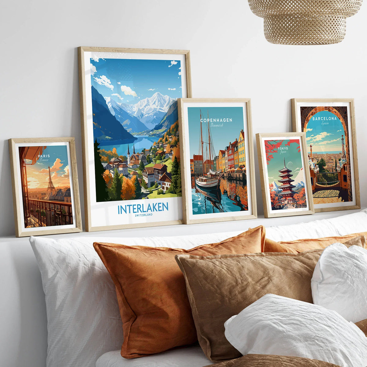 Interlaken Print in a gallery wall set of five framed travel prints in natural wood frames above a bed