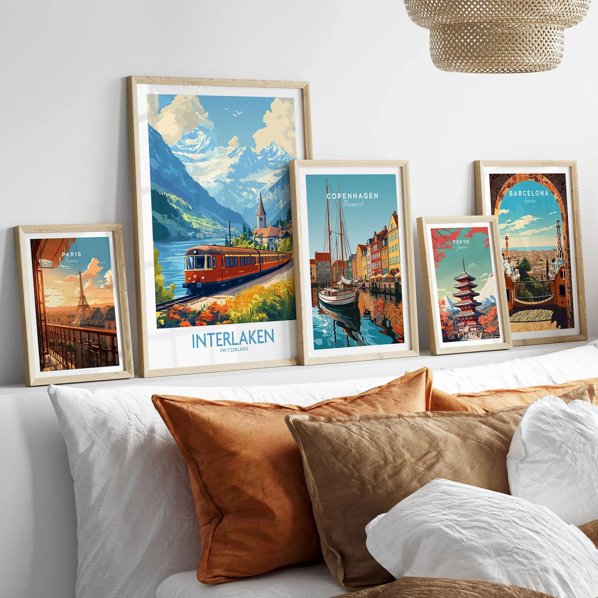 Interlaken Travel Poster in a gallery wall set of five framed travel prints in natural wood frames above a bed