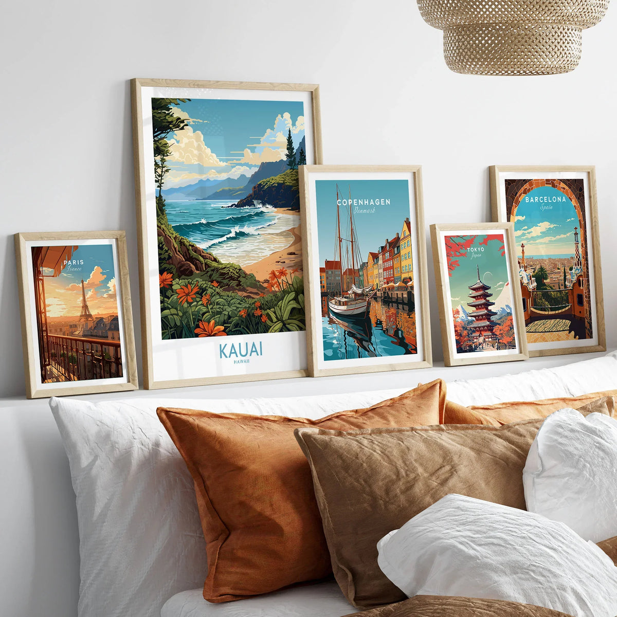 Kauai Travel Poster in a gallery wall set of five framed travel prints in natural wood frames above a bed