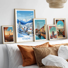 Kitzbuhel Austria Art Print in a gallery wall set of five framed travel prints in natural wood frames above a bed