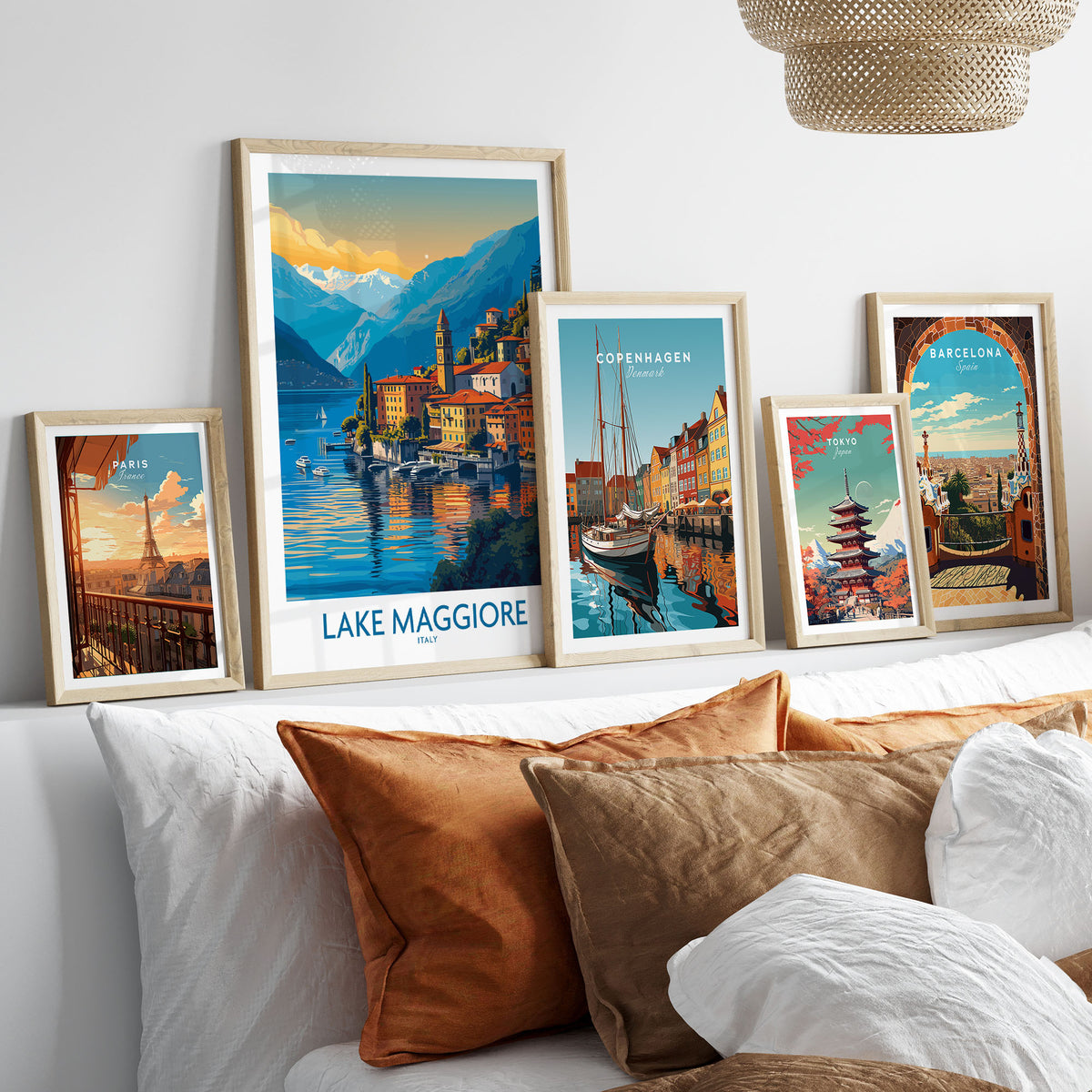 Lake Maggiore Italy Poster in a gallery wall set of five framed travel prints in natural wood frames above a bed