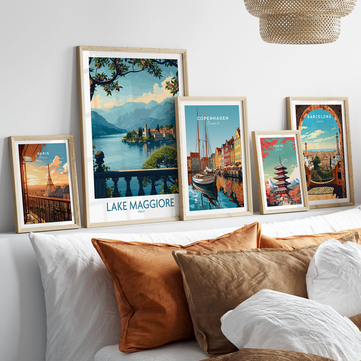 Lake Maggiore Poster Italy in a gallery wall set of five framed travel prints in natural wood frames above a bed