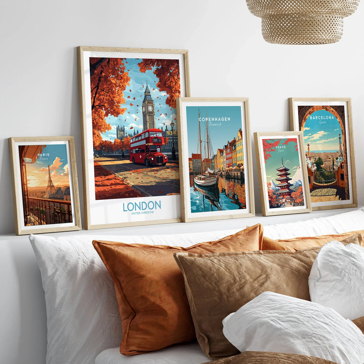 London Travel Poster in a gallery wall set of five framed travel prints in natural wood frames above a bed