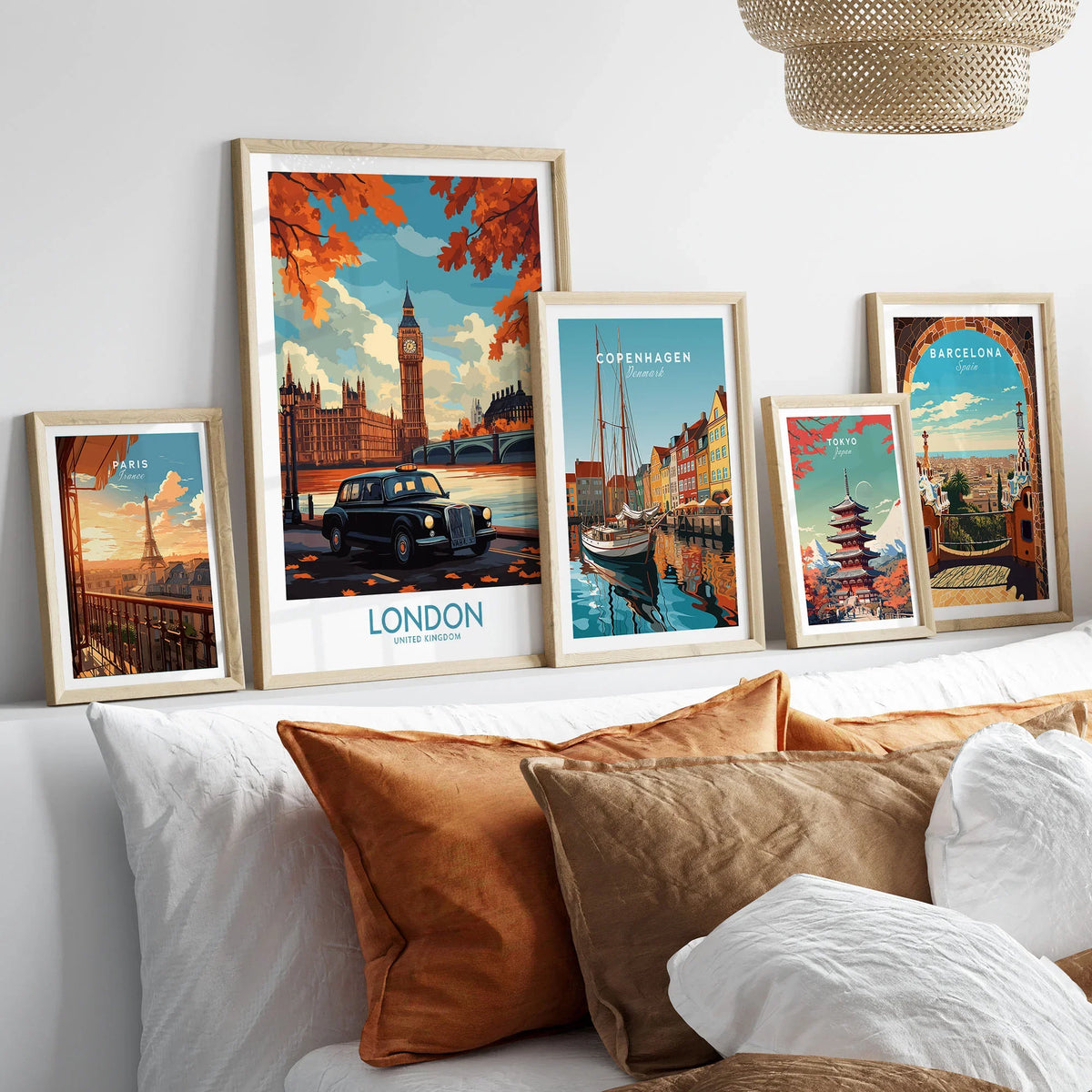 London Wall Art Print - Modern in a gallery wall set of five framed travel prints in natural wood frames above a bed