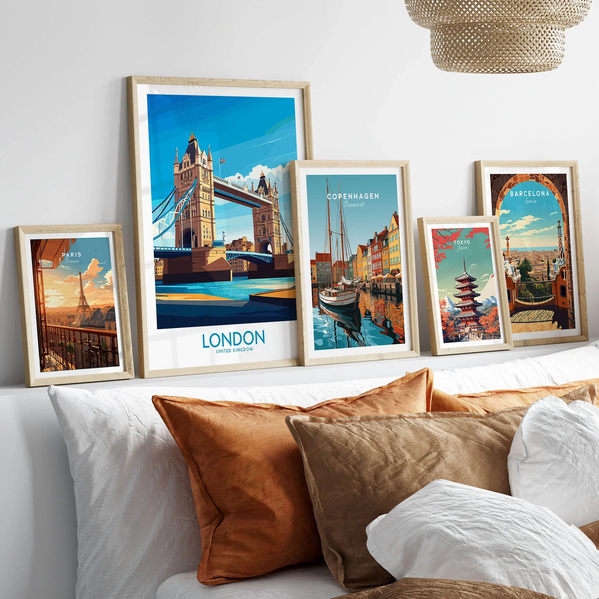 London Poster England in a gallery wall set of five framed travel prints in natural wood frames above a bed