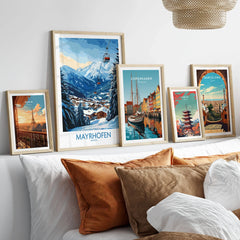 Mayrhofen Ski Poster in a gallery wall set of five framed travel prints in natural wood frames above a bed
