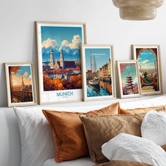Munich Travel Poster in a gallery wall set of five framed travel prints in natural wood frames above a bed