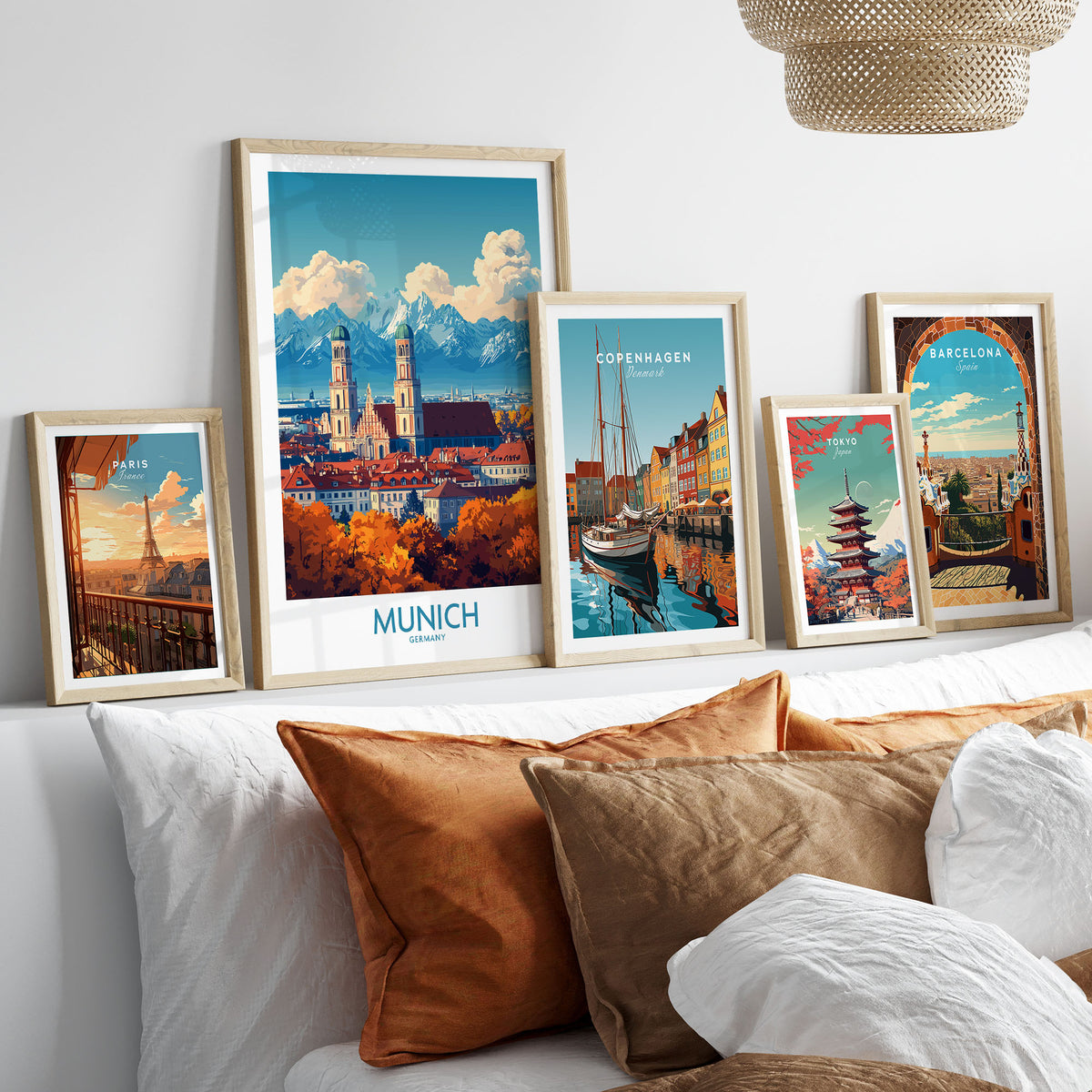 Munich Travel Poster in a gallery wall set of five framed travel prints in natural wood frames above a bed