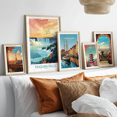 Niagara Falls Poster in a gallery wall set of five framed travel prints in natural wood frames above a bed