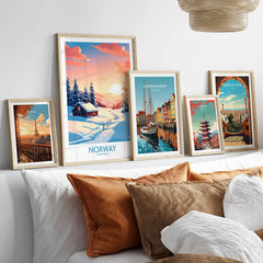 Norway Poster Print in a gallery wall set of five framed travel prints in natural wood frames above a bed