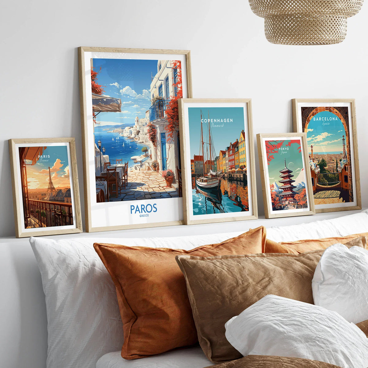 Paros Wall Art Greece in a gallery wall set of five framed travel prints in natural wood frames above a bed