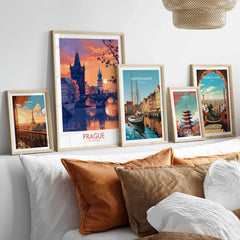 Prague Print in a gallery wall set of five framed travel prints in natural wood frames above a bed