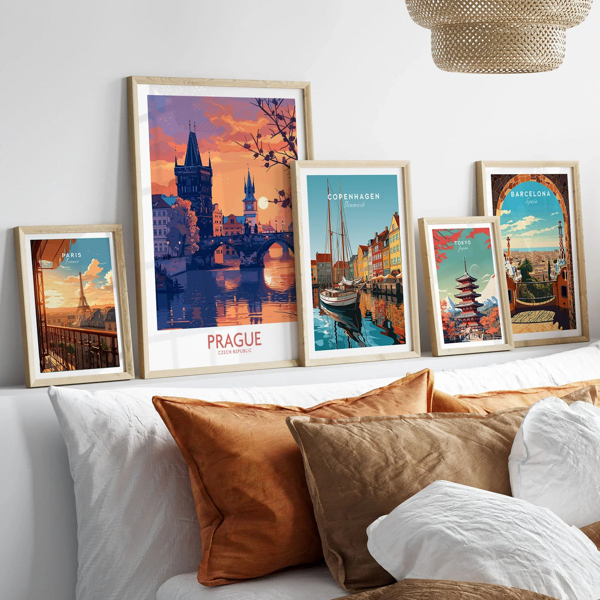Prague Print in a gallery wall set of five framed travel prints in natural wood frames above a bed