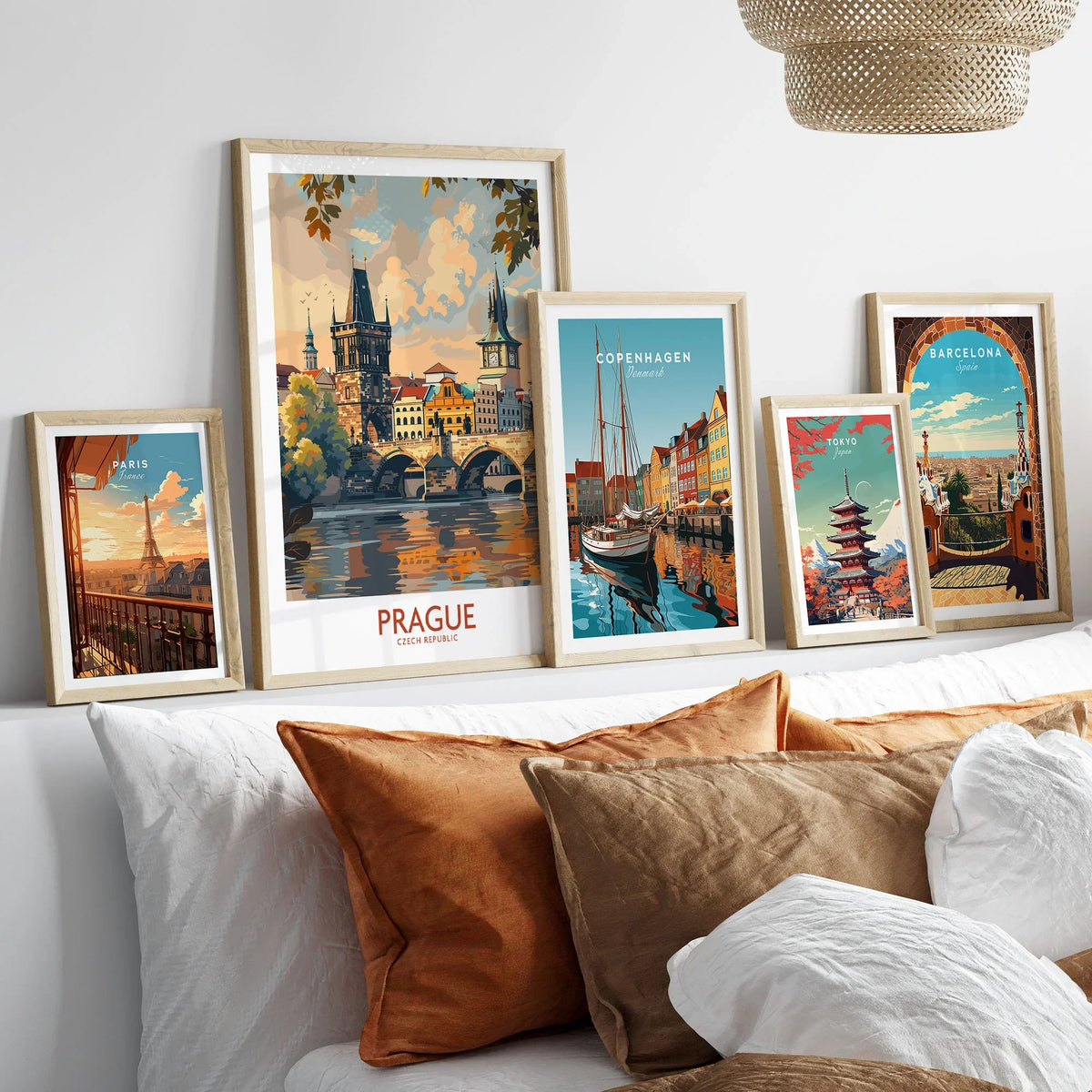 Prague Travel Poster in a gallery wall set of five framed travel prints in natural wood frames above a bed