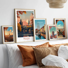 Prague Travel Print in a gallery wall set of five framed travel prints in natural wood frames above a bed