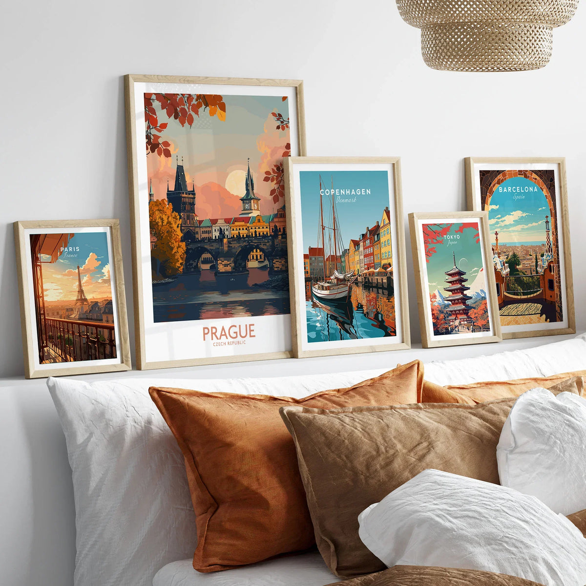 Prague Travel Print in a gallery wall set of five framed travel prints in natural wood frames above a bed