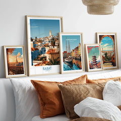 Rabat Morocco Minaret Skyline Wall Art — medina rooftops and a pale minaret in late afternoon sun, shown as set five framed artprints above bed natural wood frames