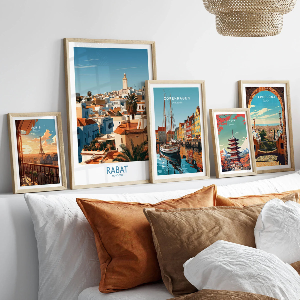 Rabat Morocco Minaret Skyline Wall Art — medina rooftops and a pale minaret in late afternoon sun, shown as set five framed artprints above bed natural wood frames