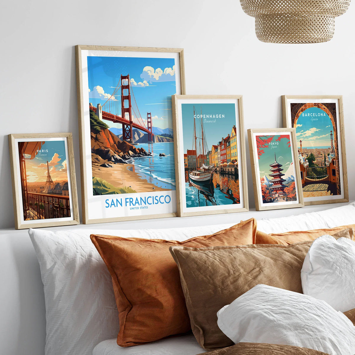 San Francisco Poster in a gallery wall set of five framed travel prints in natural wood frames above a bed
