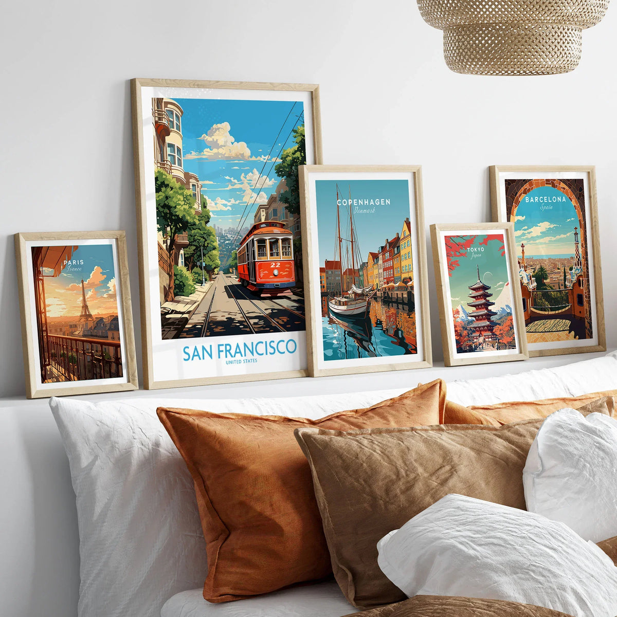 San Francisco Wall Prints in a gallery wall set of five framed travel prints in natural wood frames above a bed