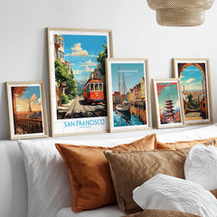 San Francisco Wall Prints in a gallery wall set of five framed travel prints in natural wood frames above a bed