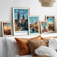 Santiago de Compostela Art Print | Galician Travel Poster in a gallery wall set of five framed travel prints in natural wood frames above a bed