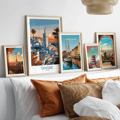 Tangier Morocco Sailboats and Rooftops Wall Art — Tangier medina rooftops and a minaret above a bay dotted with sails, shown as set five framed artprints above bed natural wood frames