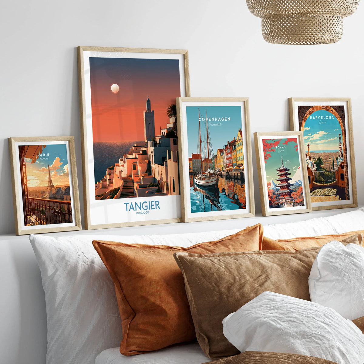 Tangier Morocco Coastal Sunset Wall Art — a whitewashed hillside town and minaret glowing above the sea at sunset, shown as set five framed artprints above bed natural wood frames