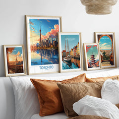 Toronto Wall Art Print in a gallery wall set of five framed travel prints in natural wood frames above a bed