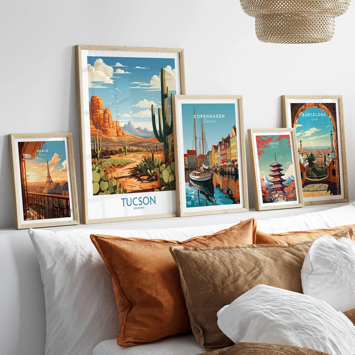 Tucson Arizona Wall Art in a gallery wall set of five framed travel prints in natural wood frames above a bed