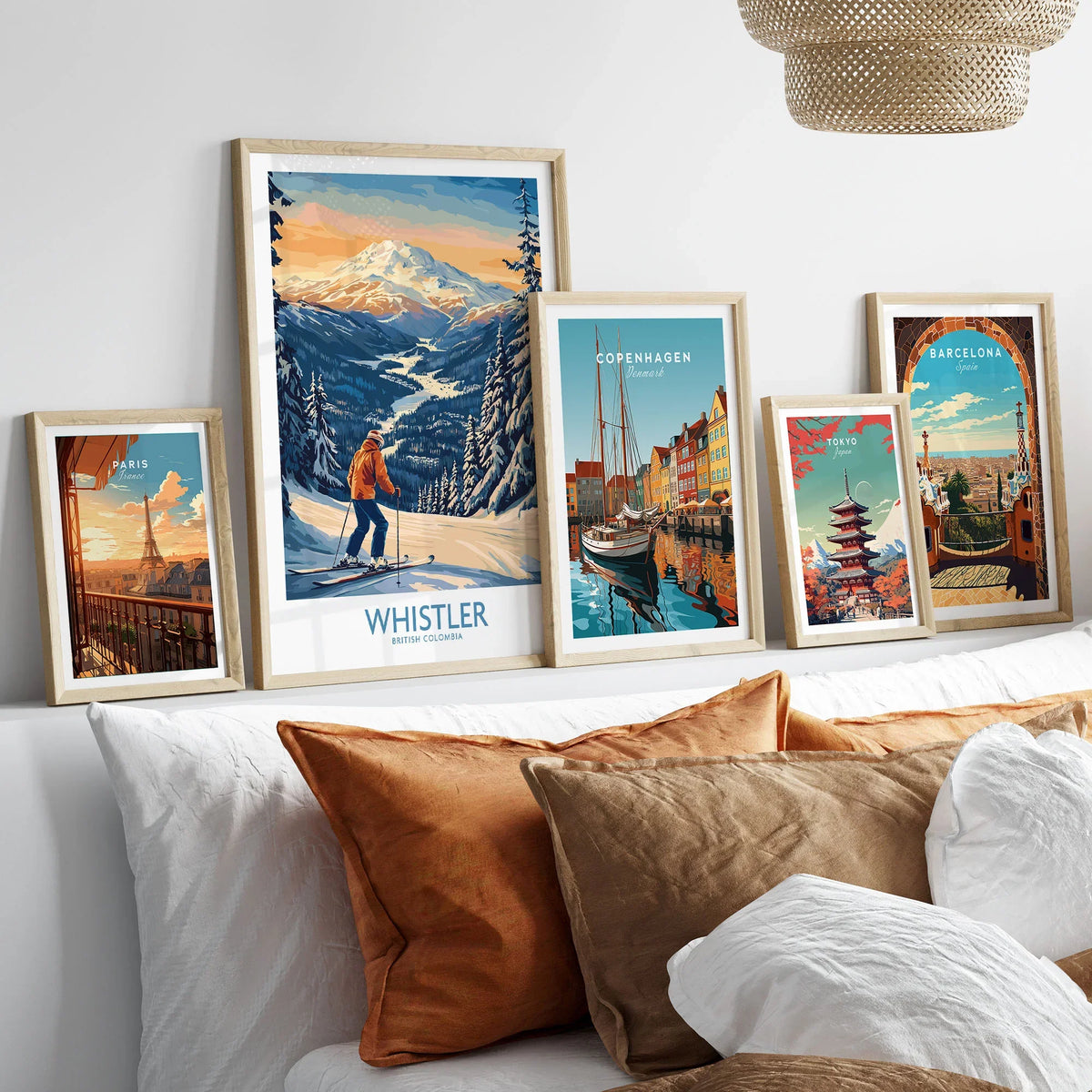 Whistler Ski Print - British Columbia in a gallery wall set of five framed travel prints in natural wood frames above a bed