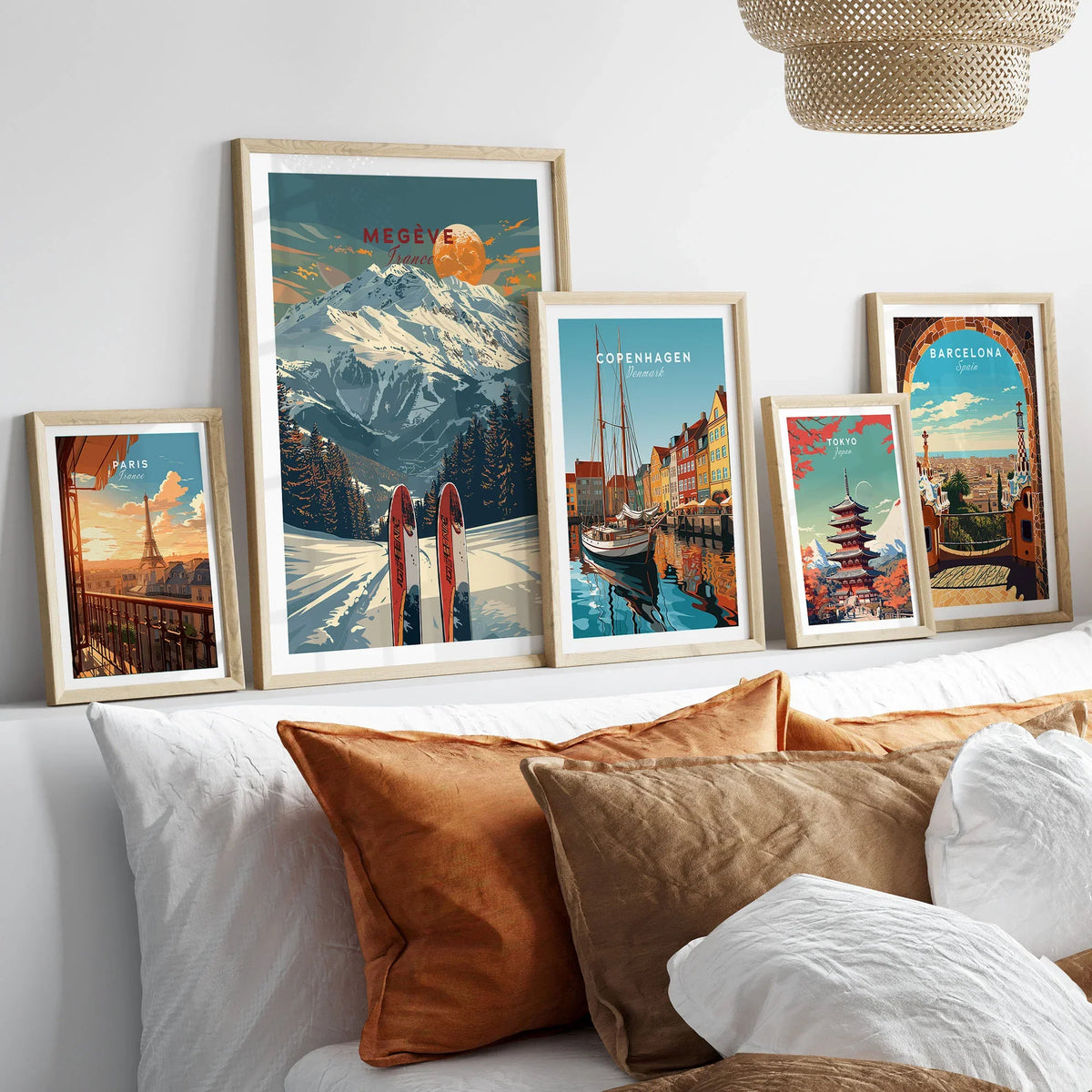 Megève Travel Poster - France in a gallery wall set of five framed travel prints in natural wood frames above a bed