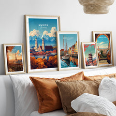 Munich Travel Print in a gallery wall set of five framed travel prints in natural wood frames above a bed