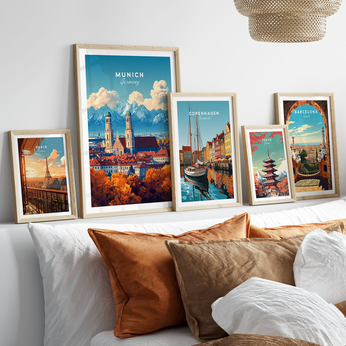 Munich Travel Print in a gallery wall set of five framed travel prints in natural wood frames above a bed