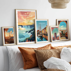 Niagara Falls Print in a gallery wall set of five framed travel prints in natural wood frames above a bed