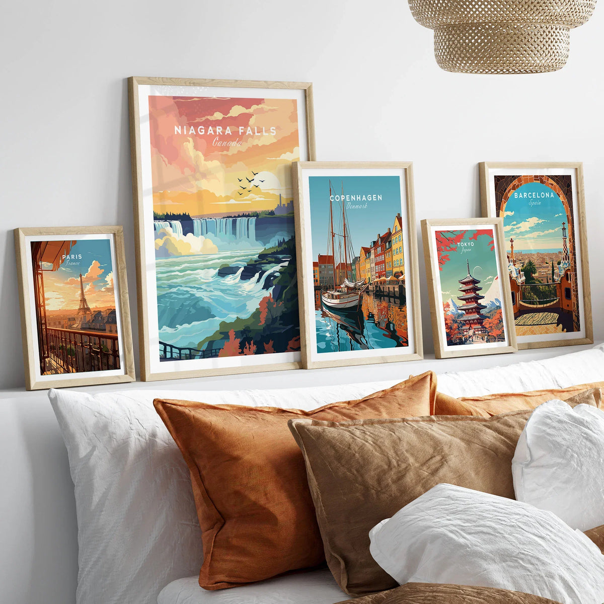 Niagara Falls Print in a gallery wall set of five framed travel prints in natural wood frames above a bed