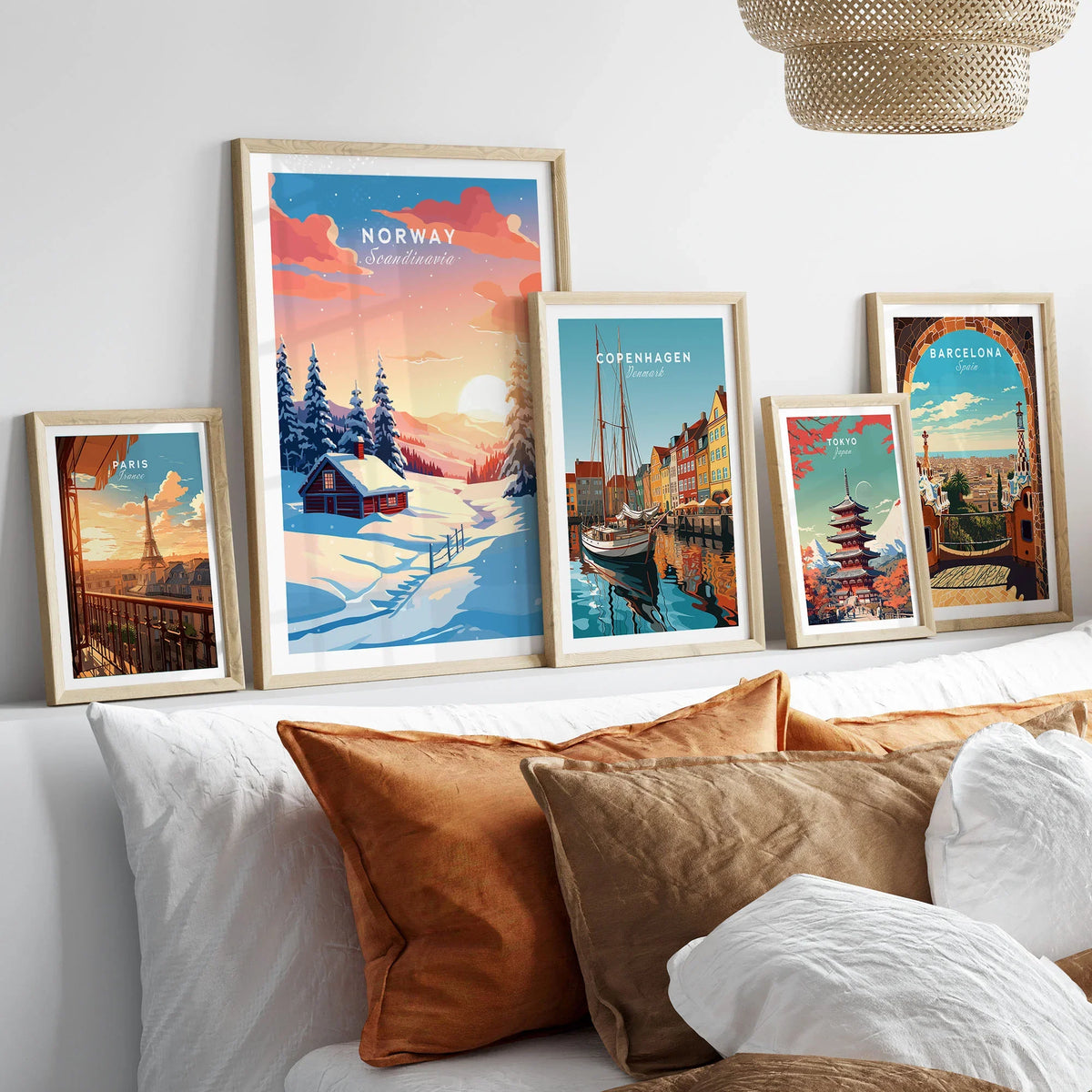 Norway Art Print in a gallery wall set of five framed travel prints in natural wood frames above a bed