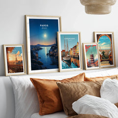 Paros Greece Print in a gallery wall set of five framed travel prints in natural wood frames above a bed