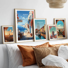 Paros Travel Poster in a gallery wall set of five framed travel prints in natural wood frames above a bed