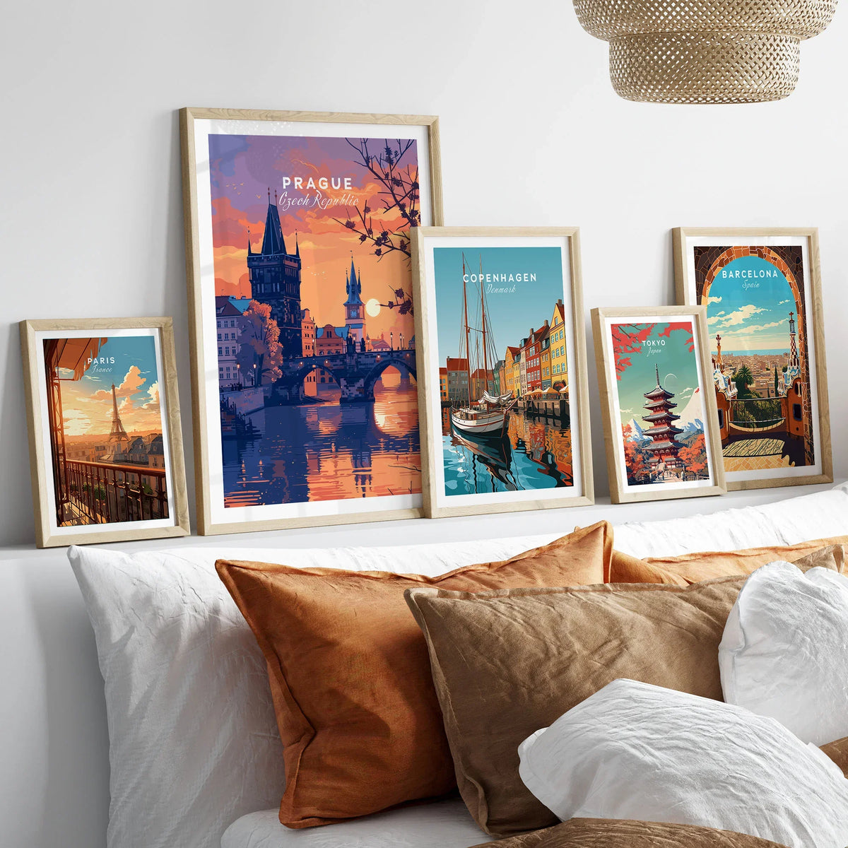 Prague Poster in a gallery wall set of five framed travel prints in natural wood frames above a bed