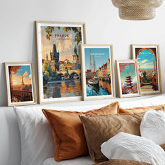 Prague Wall Art in a gallery wall set of five framed travel prints in natural wood frames above a bed