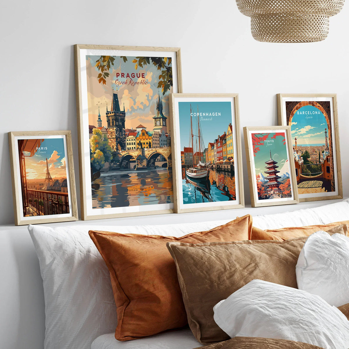 Prague Wall Art in a gallery wall set of five framed travel prints in natural wood frames above a bed