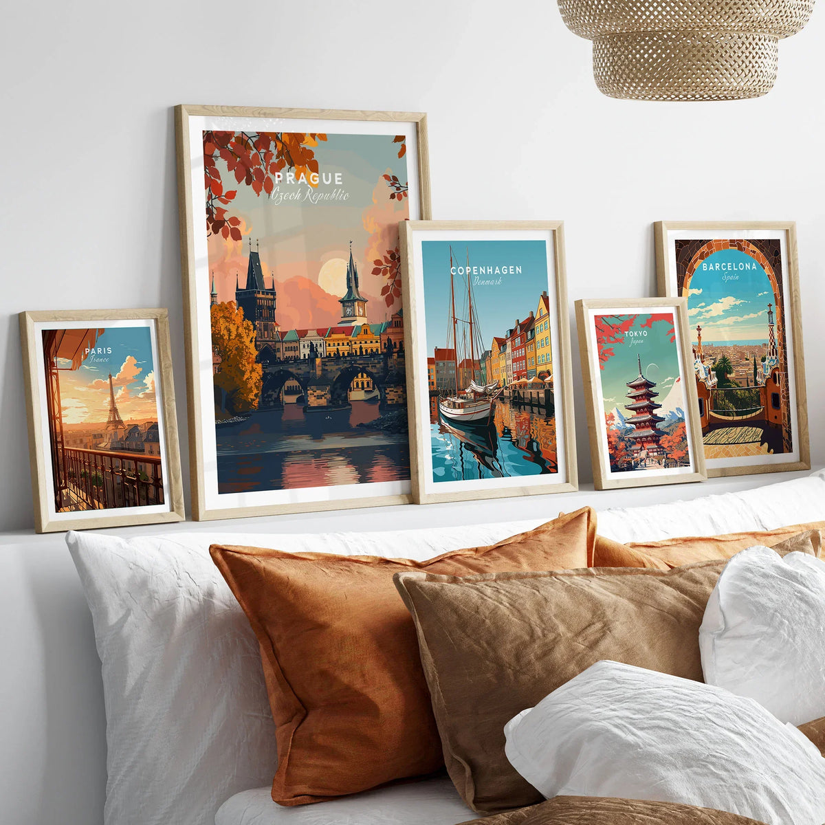 Prague Art Print in a gallery wall set of five framed travel prints in natural wood frames above a bed