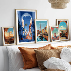 Rabat Morocco Blue Medina Travel Poster — a blue-washed medina lane and stone steps seen through a horseshoe arch, shown as set five framed artprints above bed natural wood frames