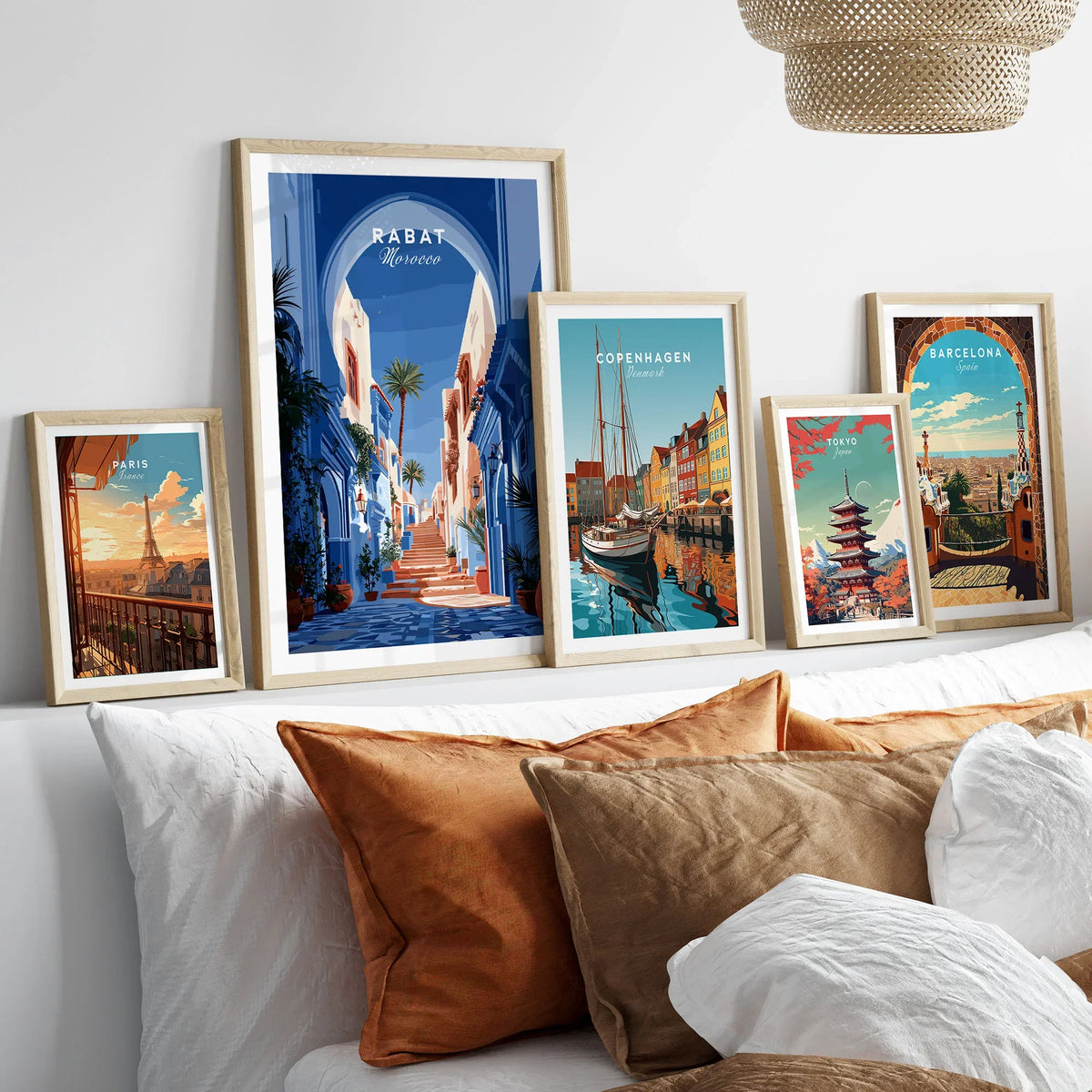 Rabat Morocco Blue Medina Travel Poster — a blue-washed medina lane and stone steps seen through a horseshoe arch, shown as set five framed artprints above bed natural wood frames