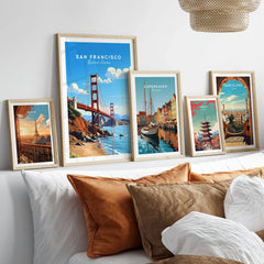 San Francisco Print in a gallery wall set of five framed travel prints in natural wood frames above a bed
